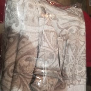 Cloth shower curtain with gray and cream French inspired print.